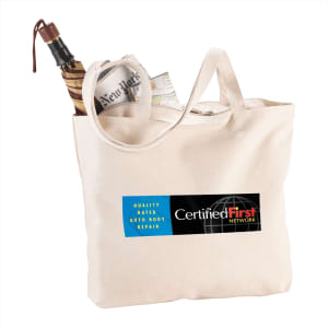 A cream zippered cotton canvas shopper tote with an umbrella, newspaper, and a map, featuring a logo.