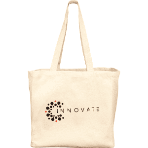 A cream-coloured reusable grocery tote bag with a logo on the front and two large handles.