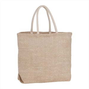 A herringbone-patterned jute tote in a natural beige colour with sturdy handles. It has a simple, stylish design.