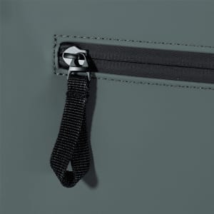 A close-up of the grey Resi Recycled Roll-Top 18L Backpack showing the zip and pull tab design.