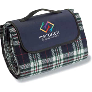 A folded picnic rug in dark blue and green plaid, featuring a handle and a logo.