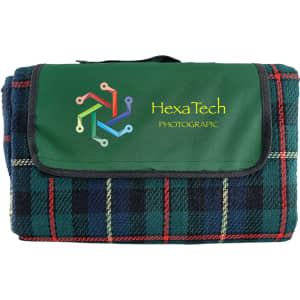 A folded picnic rug featuring a green and tartan check pattern, with a logo on the front.
