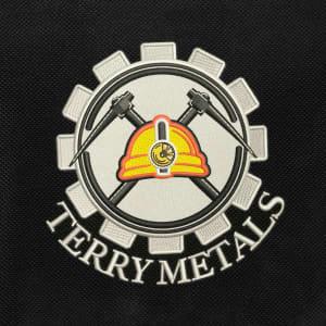 A logo featuring a gear, crossed hammers, and a hard hat, with the text "TERRY METALS".
