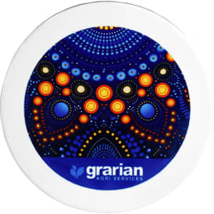 A circular ceramic coaster featuring a vibrant blue and orange design with dots, surrounded by a white border and a logo.
