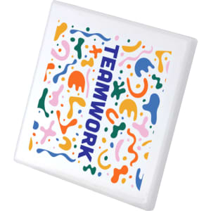 A square ceramic coaster featuring a vibrant, abstract design in multiple colours with the word "TEAMWORK."