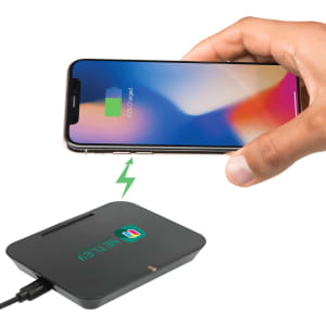 A black wireless charging phone stand with a connected cable, and a smartphone above it showing a charging icon.