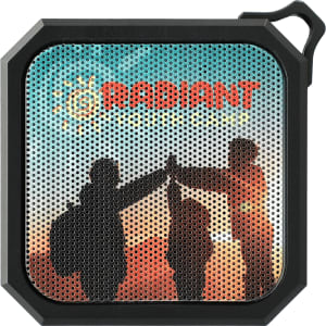 A black, square waterproof Bluetooth speaker with a perforated mesh design and a coloured image featuring silhouettes of people.