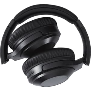 Black Anton ANC Headphones with cushioned ear pads, folded for compact storage, featuring a logo on the side.