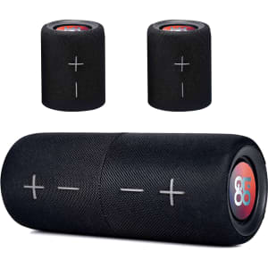 A black Breakaway Bluetooth speaker with volume controls, featuring a discreet logo. Two smaller speakers are also visible.