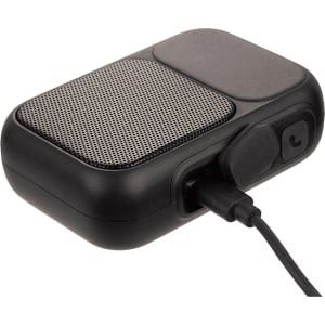 A black Bluetooth speaker with a textured grille and charging port, featuring a sleek, compact design.