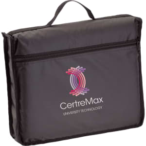 A black picnic rug in a carry bag featuring a logo, with a handle for easy transport.