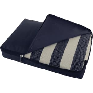 A picnic rug with a black waterproof backing, folded and zipped inside a protective cover featuring striped fabric.