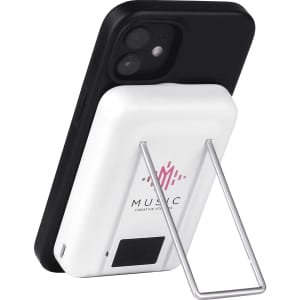 A white magnetic power bank with a phone stand, featuring a silver stand and a black phone attached.