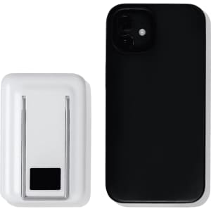 A white magnetic power bank with a phone stand next to a black smartphone. The power bank features a logo.
