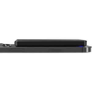 A slim black metal power bank positioned on a mobile device, featuring a sleek design and a logo.