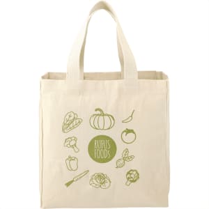 A cream-coloured reusable grocery tote with an illustration of various vegetables and a logo.