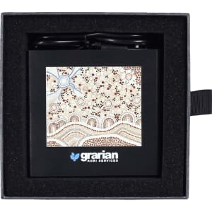 A black 3-in-1 charger with a patterned design, placed in a black cushioned box. Features a logo on the front.