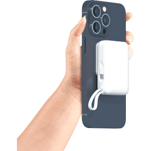 A white Infinity Magnetic Powerbank 10000 mAh attached to a dark blue smartphone, held in a hand.