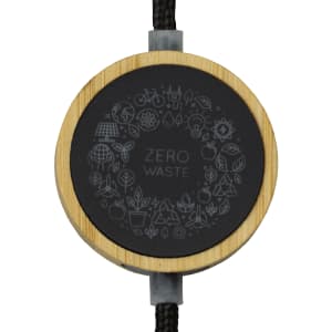 A black and bamboo circular adaptor featuring a "Zero Waste" design, attached to a braided cable.