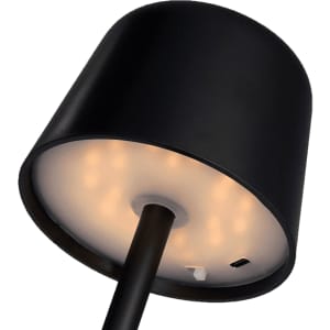 A black mini rechargeable lamp with a circular shade and visible LED lights on the underside, featuring a charging port.