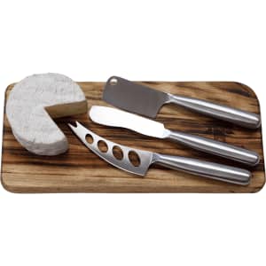 A cheese board featuring three stainless steel knives and a round wedge of cheese. The board is wooden.