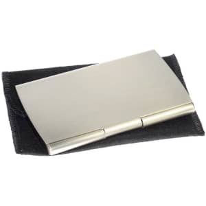 A sleek silver metal business card holder on a black velvet pouch, featuring a minimalist design and a logo.