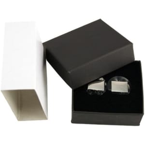 A pair of plain silver cufflinks displayed in a black box, with a white box beside it.