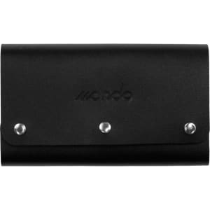 A black leather cover with metal studs, containing a travel card set. It features a branding logo.