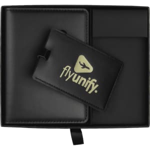 A black gift box contains a black luggage tag and a cardholder with a logo.