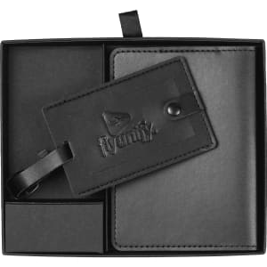 A black travel gift set featuring a luggage tag and a passport holder, presented in a sleek box with branding.