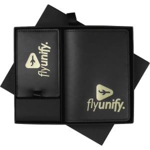 A black leather travel gift set featuring a wallet and luggage tag, both with a logo.