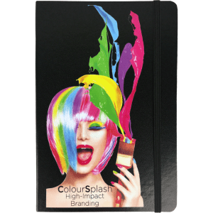 A black notebook with a colourful, artistic design featuring a vibrant wig and paint splashes. There is a logo on the cover.