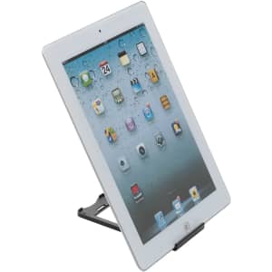 A black plastic tablet stand holding a white tablet at an angle, displaying a home screen with various app icons.