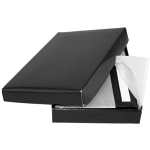 A sleek black business card holder in an open box, featuring a soft lining and a minimalist design.