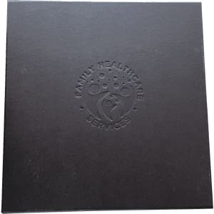 A black box with an embossed logo featuring a family and the words "Family Healthcare Services."