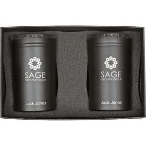 A gift box containing two black tumblers with a logo, placed in a protective foam insert.