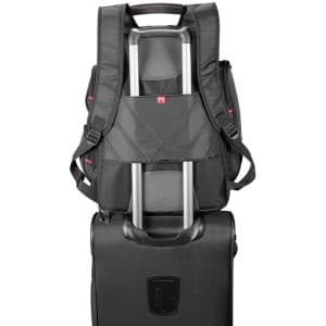 A black checkpoint-friendly backpack featuring multiple storage compartments and straps for easy transport on a trolley.