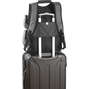 A grey backpack with multiple compartments sits atop a black suitcase, featuring a pull handle. It has visible branding.