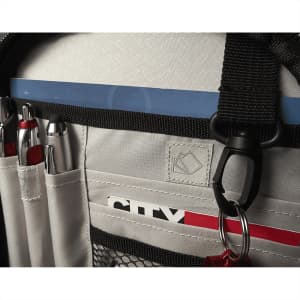 A grey backpack interior featuring pockets for pens, mesh storage, and a loop for attaching accessories.