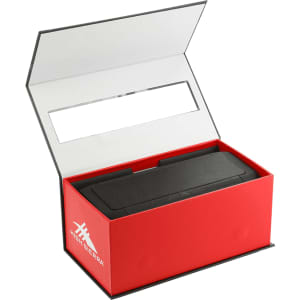 A black speaker and power bank inside a red box with a white interior and branding.