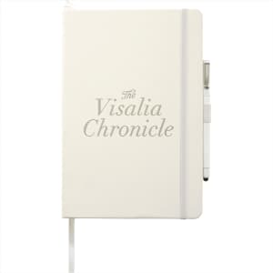 A large, hardbound journal in cream with an elastic closure and a pen holder, featuring a logo.