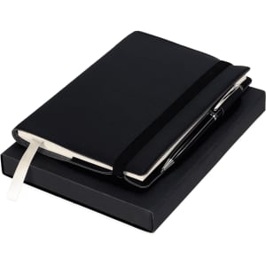 A black notebook with an elastic band and a pen, both presented in a black gift box.
