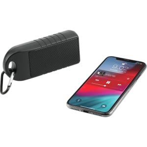 A black Bluetooth speaker with a textured surface and a carabiner, alongside a smartphone displaying a music app.