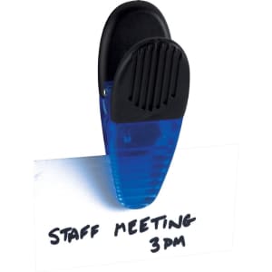A blue magnetic memo holder clip is grasping a white note with handwritten text on it.