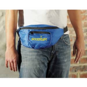 A blue bum bag with a front zip pocket and a logo is worn around the waist of a person.