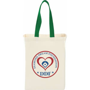 A natural cotton grocery tote in cream with green handles, featuring a round logo on one side.