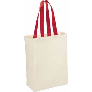 A natural cotton grocery tote in cream with red handles, featuring a logo on one side.