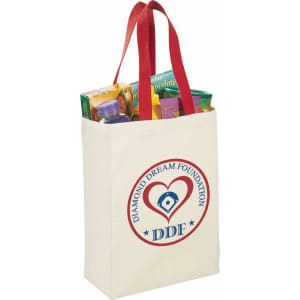 A natural cotton grocery tote in cream with red handles, featuring a logo and filled with assorted grocery items.
