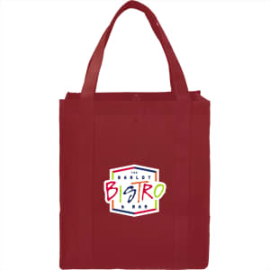 A red non-woven grocery tote bag with sturdy straps and a logo on the front.