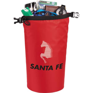 A red waterproof outdoor bag filled with various items, including a drink bottle, wallet, and phone, featuring a logo.